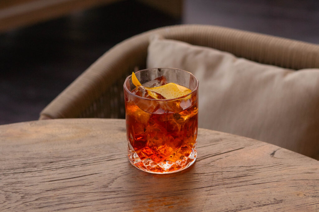 Classic Negroni cocktail with hand-cut ice and orange peel served at Klive Beach Club Uluwatu Bali.