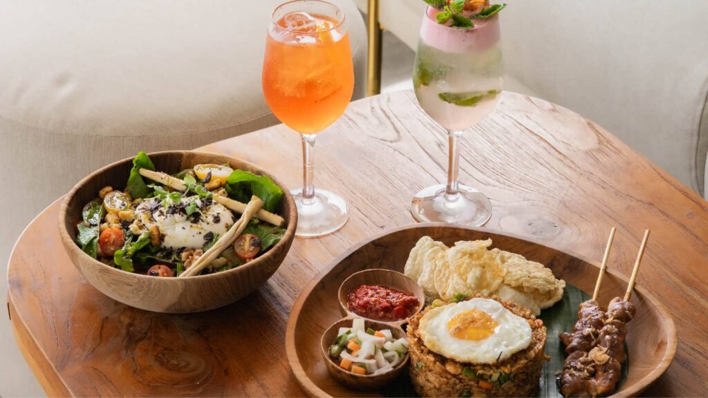 Charred Tomato and Fresh Burrata salad with Nasi Goreng Chicken and cocktails at Klive Beach Club Uluwatu.